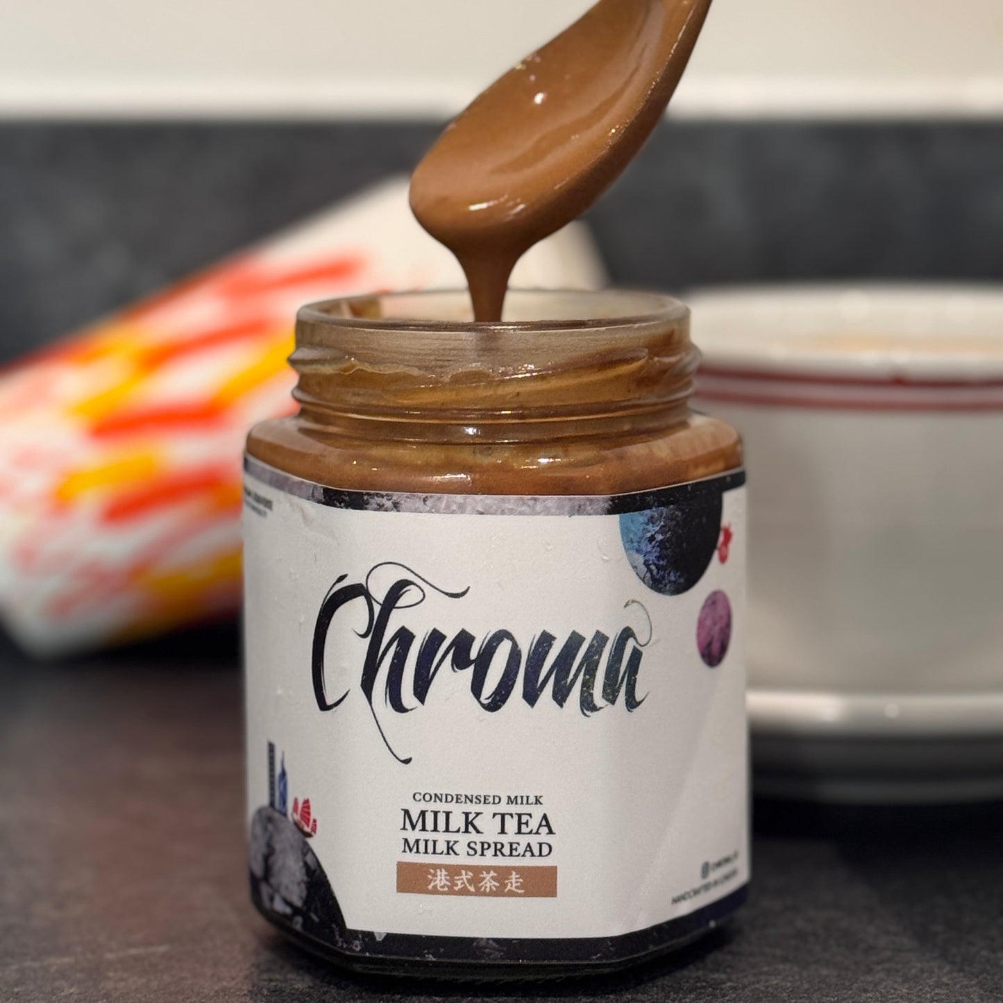 Jar of Chroma Coconuts Milk Tea Spread with a spoonful being lifted out