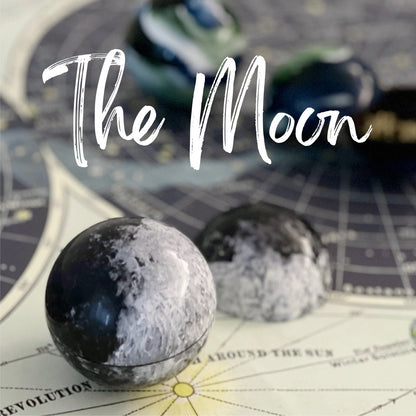 Handcrafted moon-shape chocolate ball with chocolate crunch