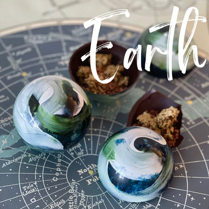 Handcrafted earth-shape chocolate ball with chocolate crunch